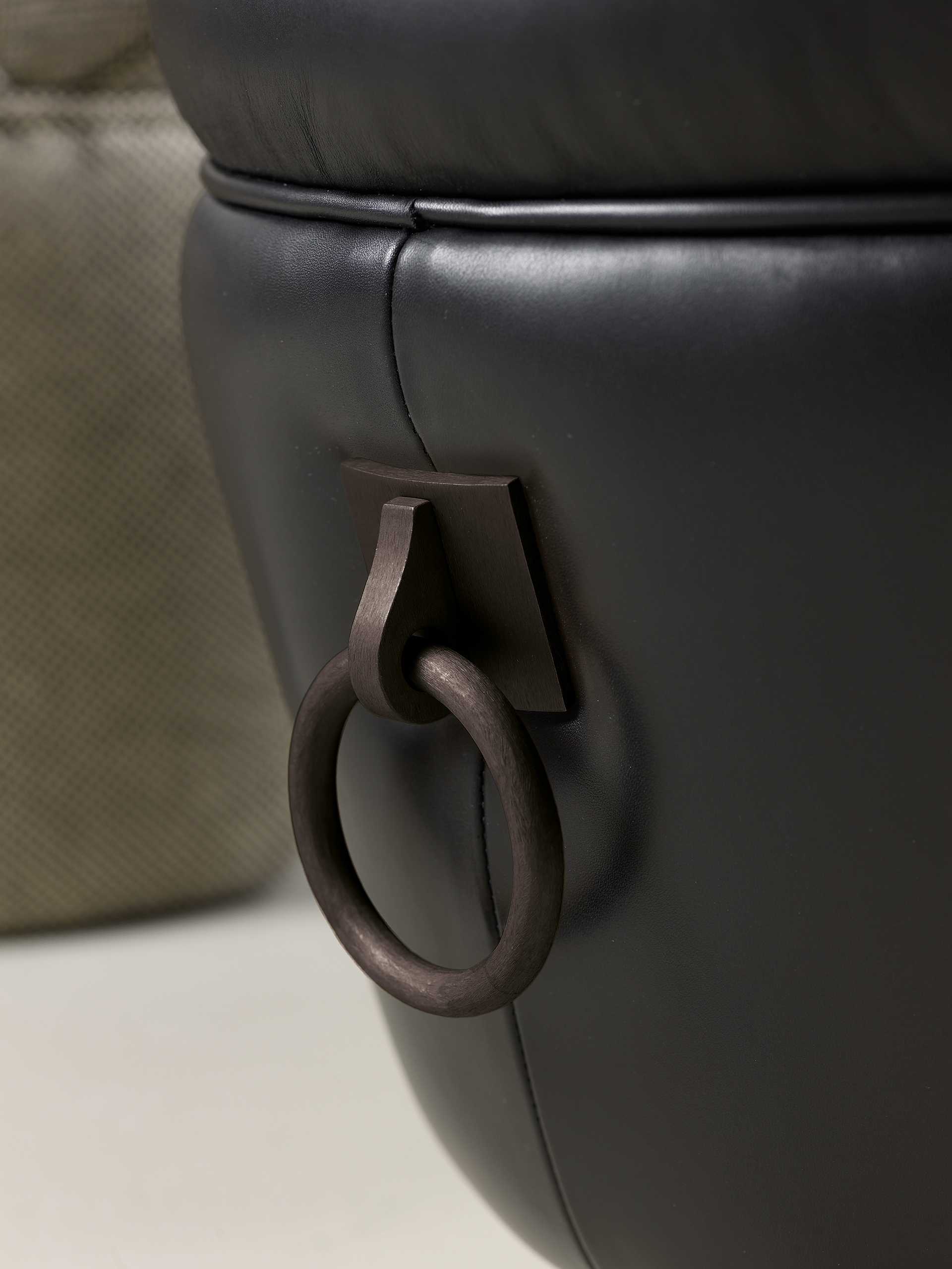 Gioconda is a pouf covered in fabric or leather with bronze handles, from Promemoria's catalogue | Promemoria