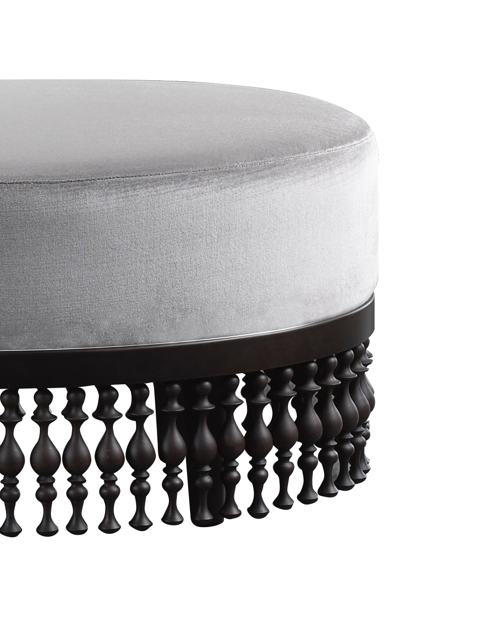 Istanbul is a fabric or leather pouf with a wooden fringed base, from Promemoria's Capsule Collection by Bruno Moinard | Promemoria