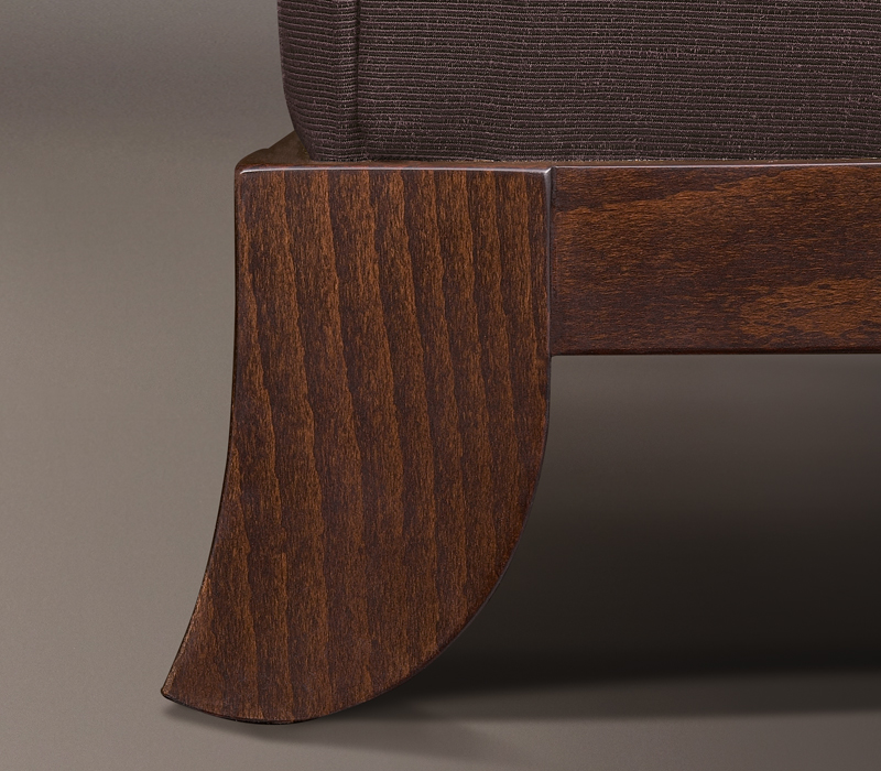 Wooden feet detail of Madame A, a wooden pouf covered in fabric or leather, from Promemoria's catalogue | Promemoria