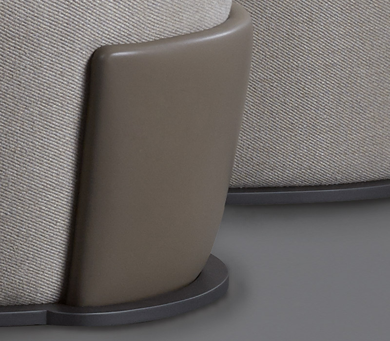 Detail of Rosaspina, a pouf covered in fabric and leather and a metal base, from Promemoria's catalogue | Promemoria