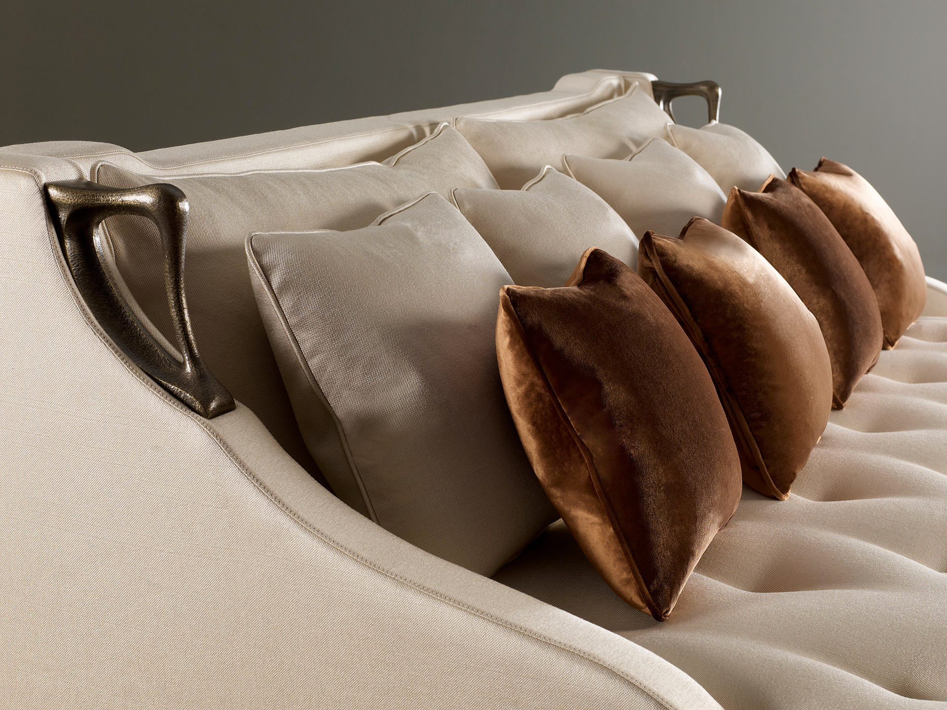 Detail of Albert, a wooden sofa covered in fabric with two bronze handles on the sides, from Promemoria's catalogue | Promemoria