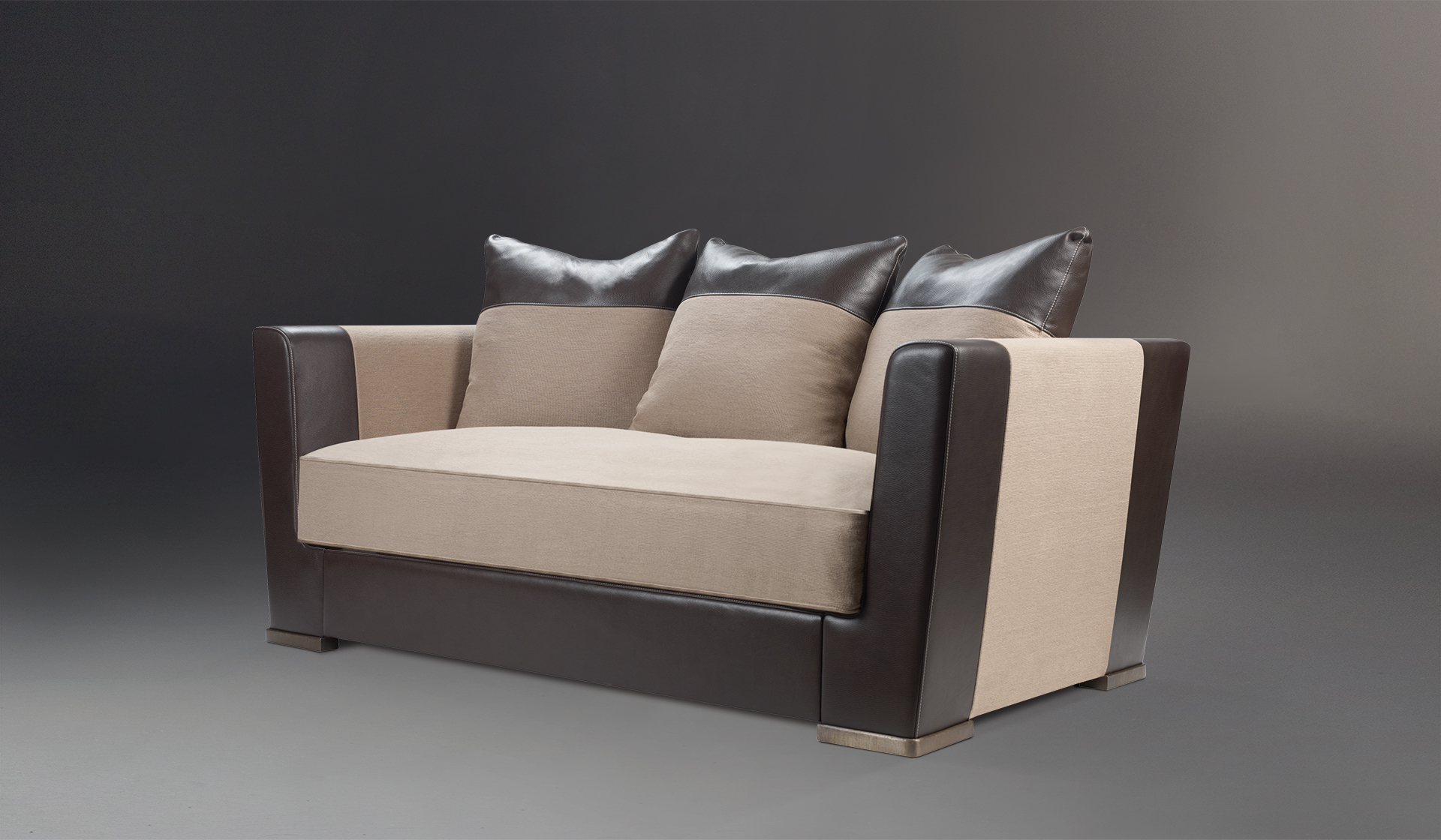 Dolce Vita is a sofa covered in fabric with leather details and bronze feet, from Promemoria's catalogue | Promemoria