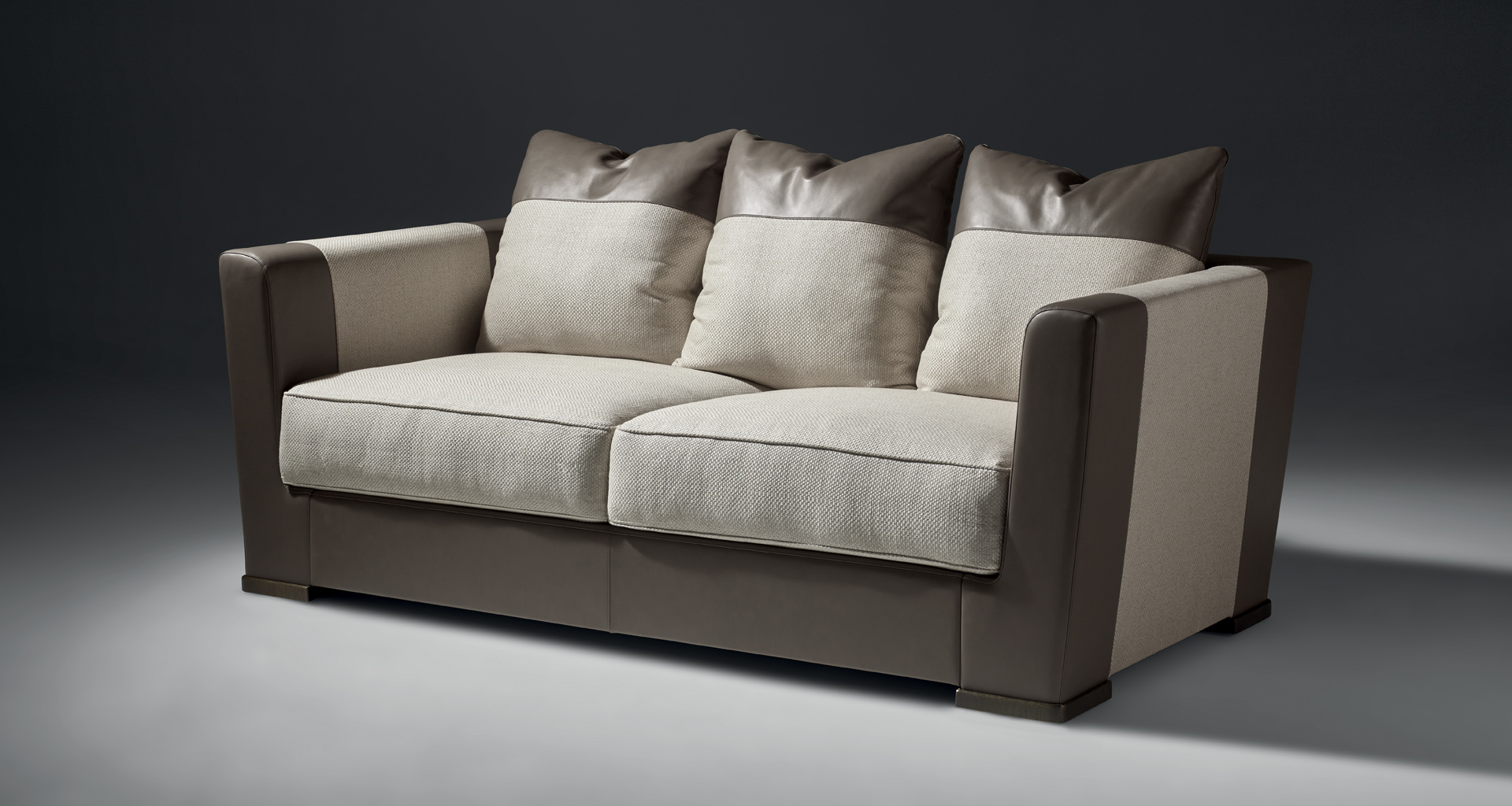 Dolce Vita is a sofa covered in fabric with leather details and bronze feet, from Promemoria's catalogue | Promemoria