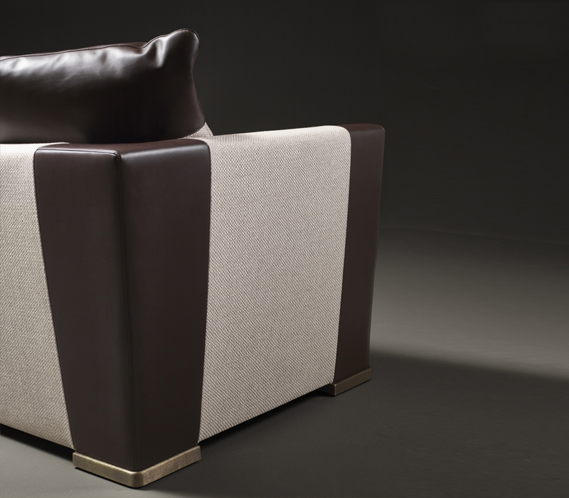 Dolce Vita is a sofa covered in fabric with leather details and bronze feet, from Promemoria's catalogue | Promemoria
