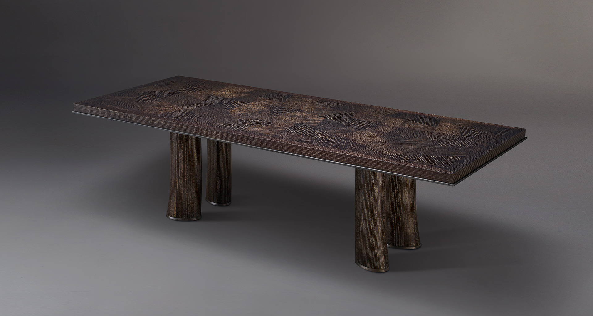Andalù is a wooden dining table with bronze profile and feet, from Promemoria's catalogue | Promemoria