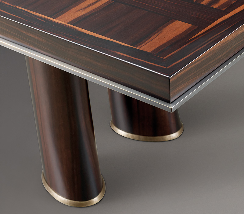 Bronze profile detail of Andalù, a wooden dining table with bronze feet, from Promemoria's catalogue | Promemoria