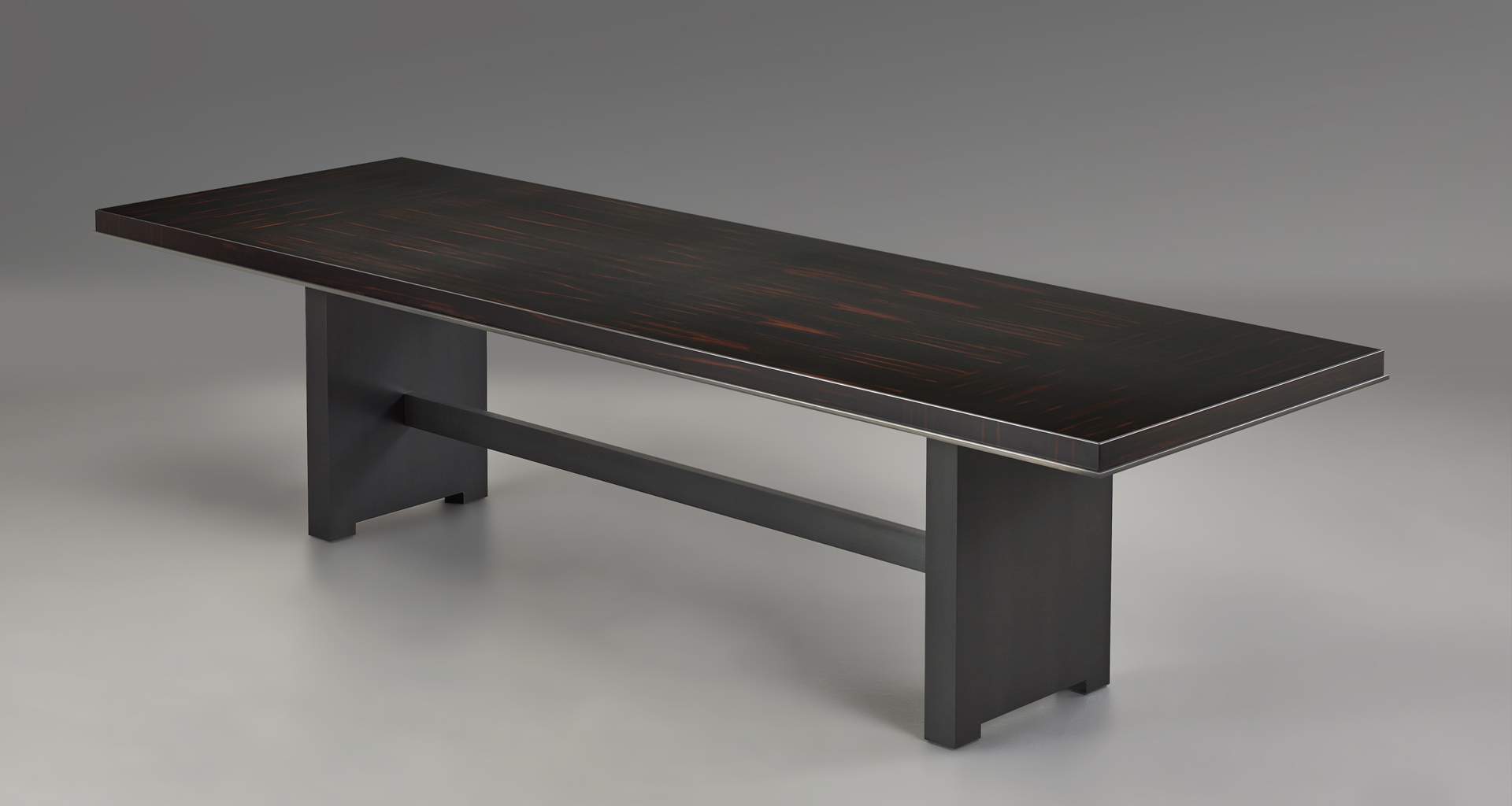 Bamboo is a wooden dining table with a bronze base, from Promemoria's catalogue | Promemoria