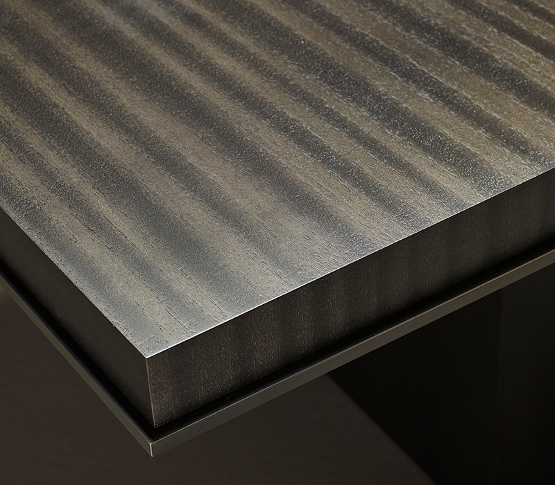 Top detail of Bamboo, a wooden dining table with a bronze base, from Promemoria's catalogue | Promemoria