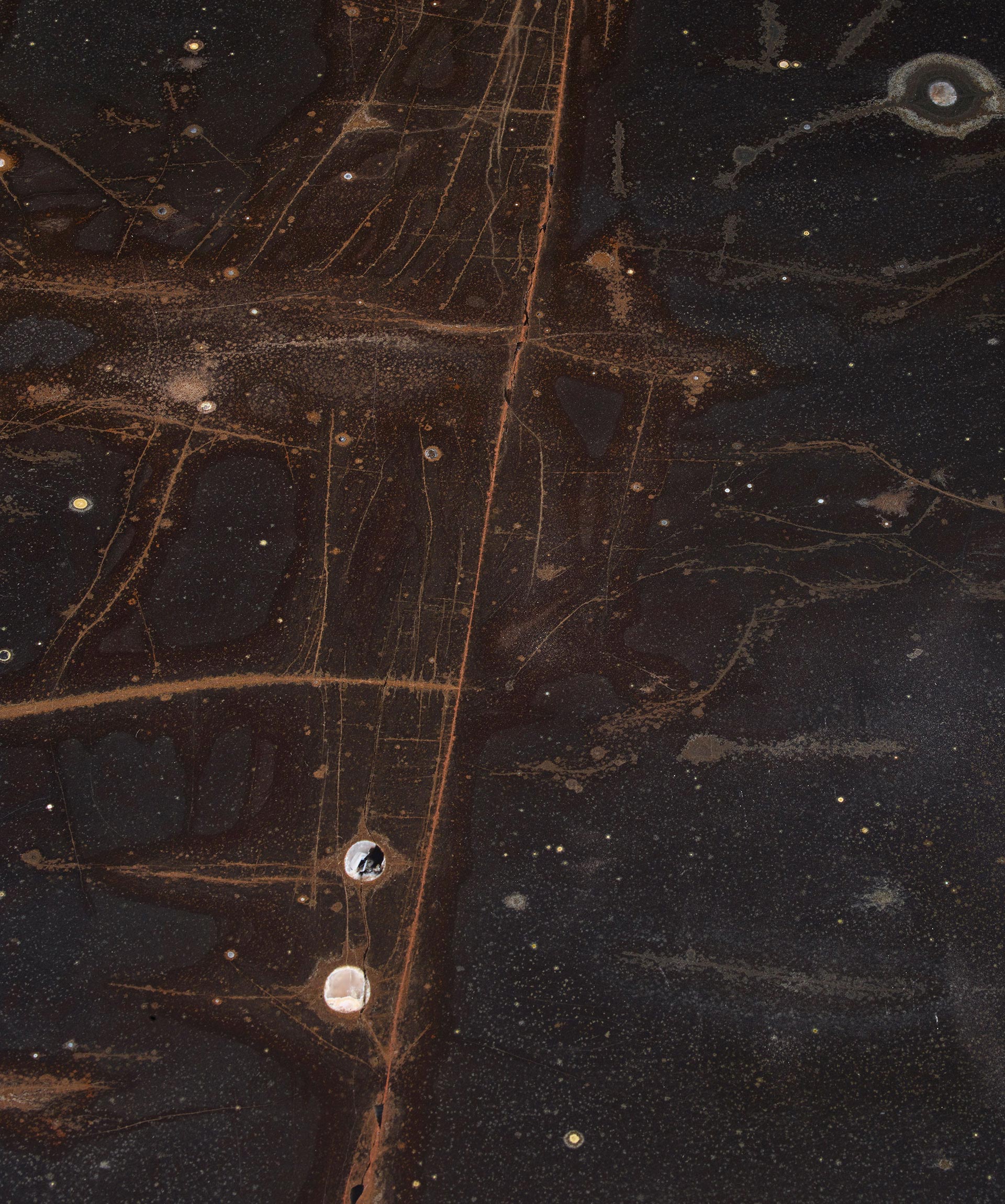 Top detail of Cadogan, a bronze dining table with available in different finishes, from Promemoria's The London Collection | Promemoria