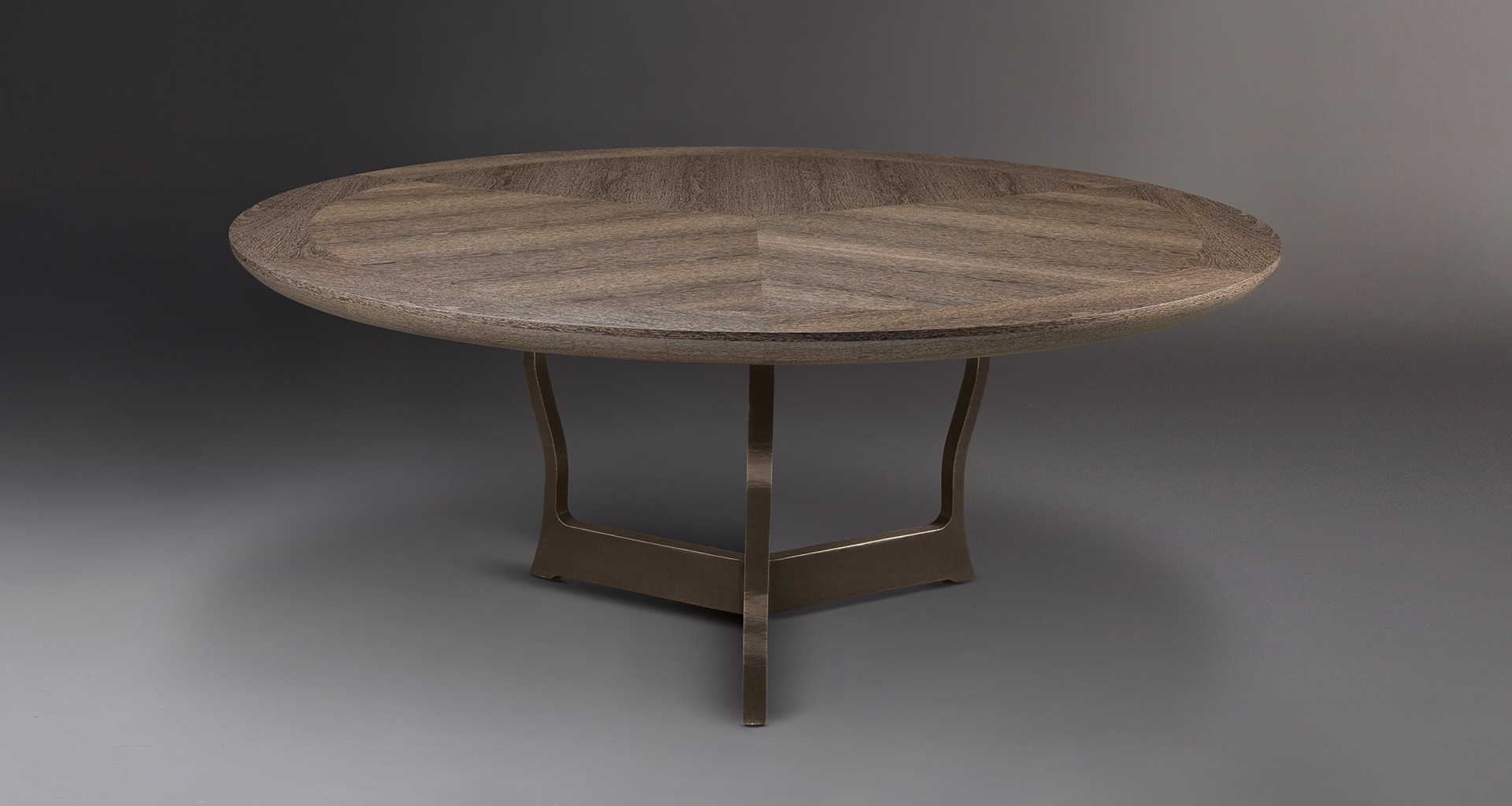 Erasmo is a bronze dining table with wooden or leather top, from Promemoria's catalogue | Promemoria