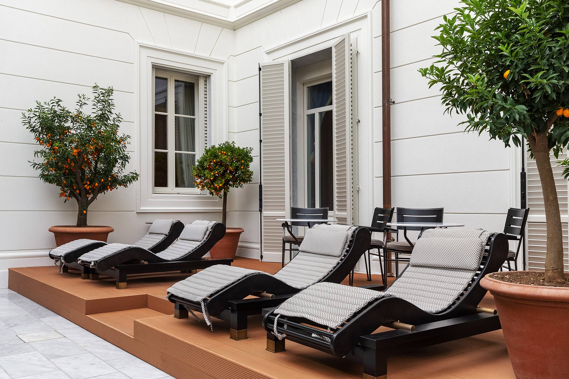 Patio of La Datcha, a luxury resort in Forte dei Marmi, Italy, furnished with Promemoria | Promemoria
